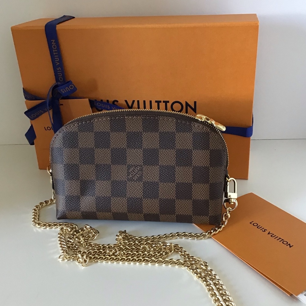 Louis Vuitton cosmetic bag with added chain.